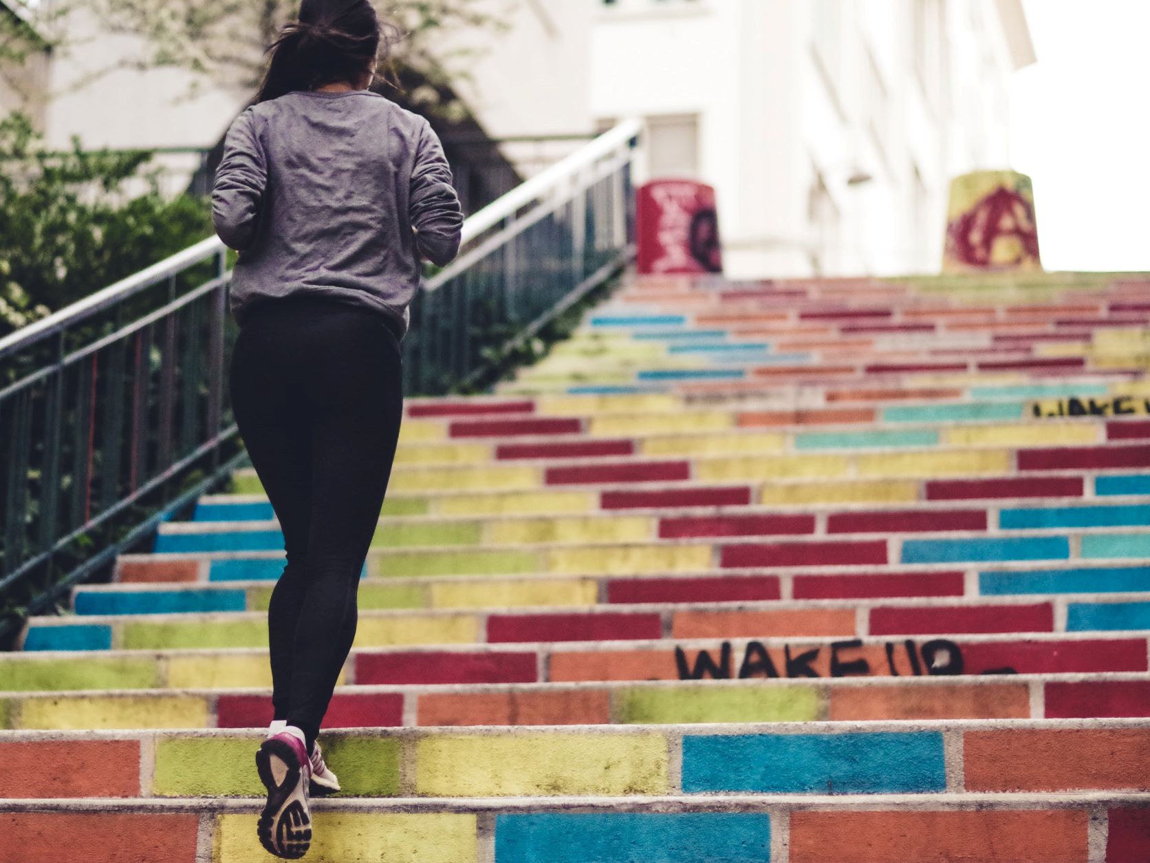 woman running on colorful stairs